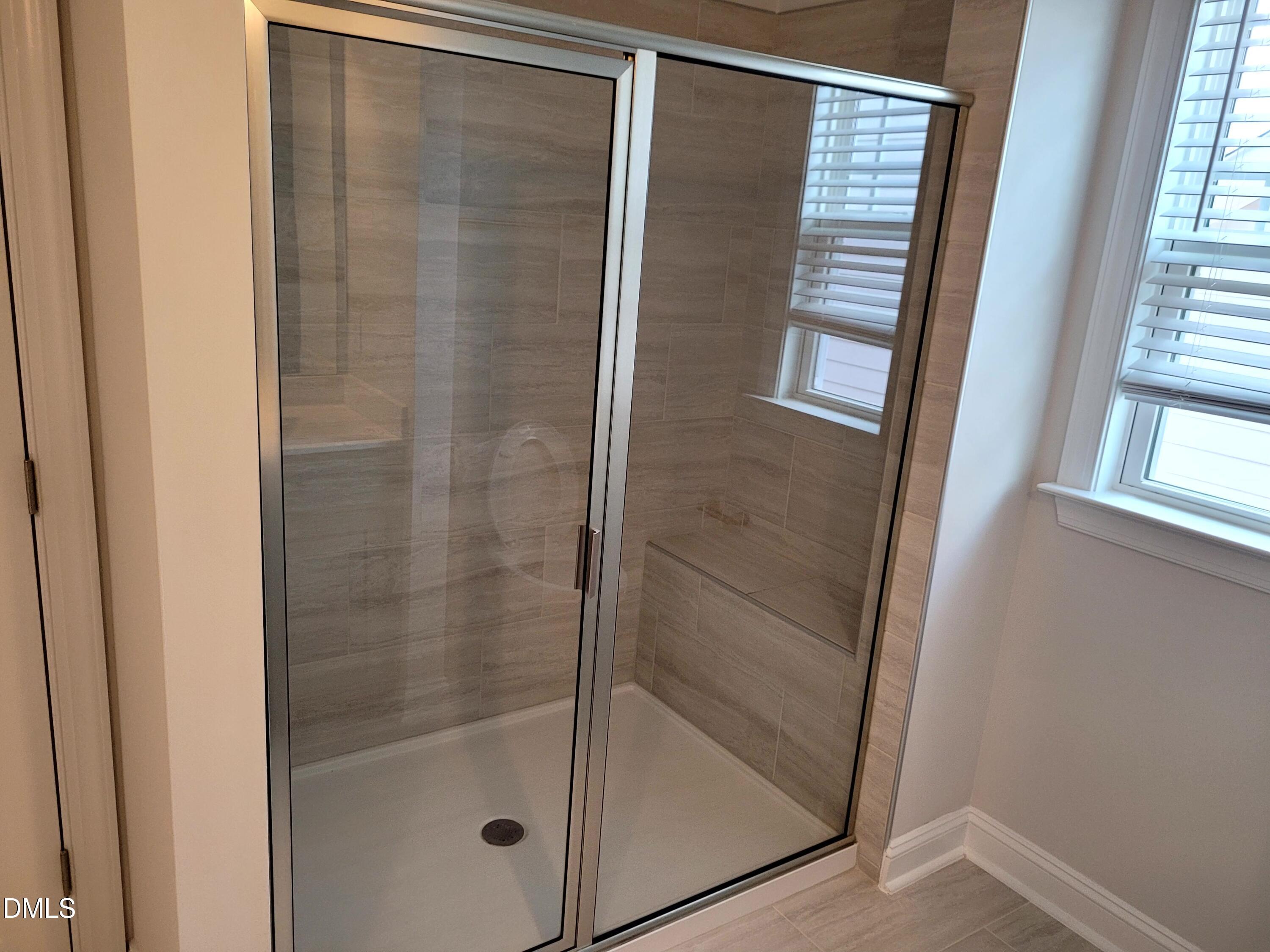 5220 Influence Way Raleigh, NC 27616 - Photo 7 of 10 a bathroom with a glass shower door