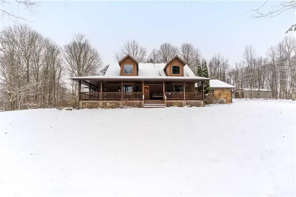 a view of a house with a yard covered in snow