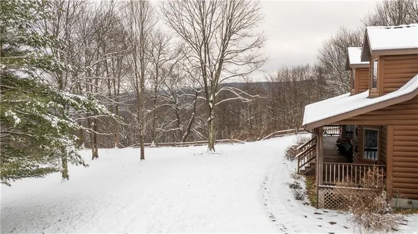 a view of house with snow on the road