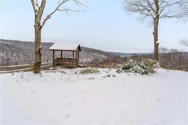 a roof deck with table and chairs under an umbrella