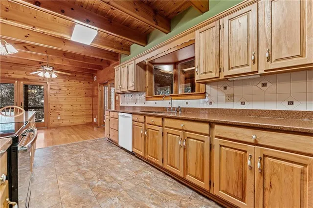 a kitchen with stainless steel appliances granite countertop a sink and cabinets
