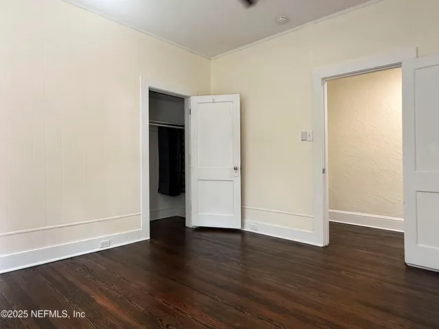 a view of room with window and wooden floor