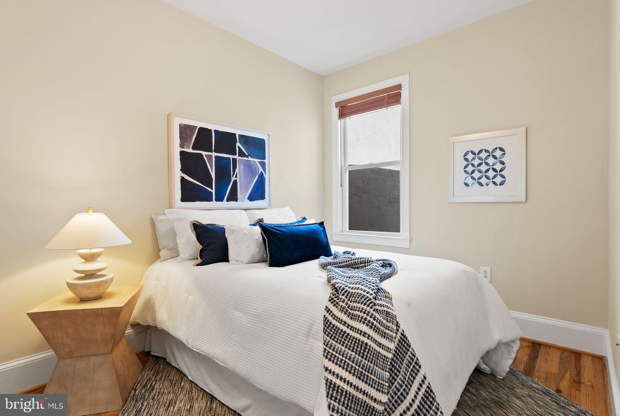 633 12th Street Northeast Washington, DC 20002 - Photo 25 of 44 a bedroom with a bed and a painting on the wall