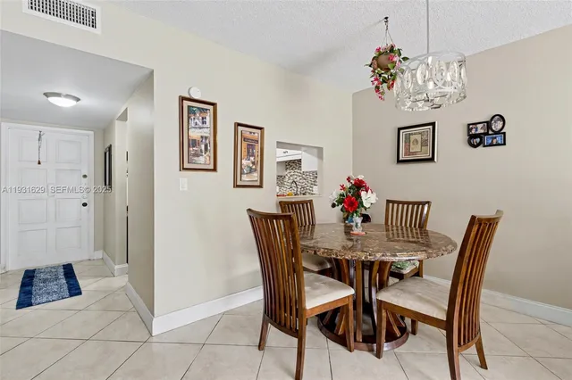 a view of a dining room with furniture and chandelier