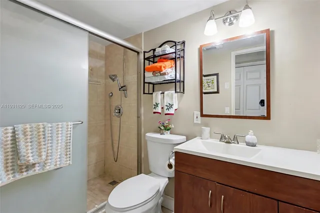 a bathroom with a sink vanity mirror and toilet