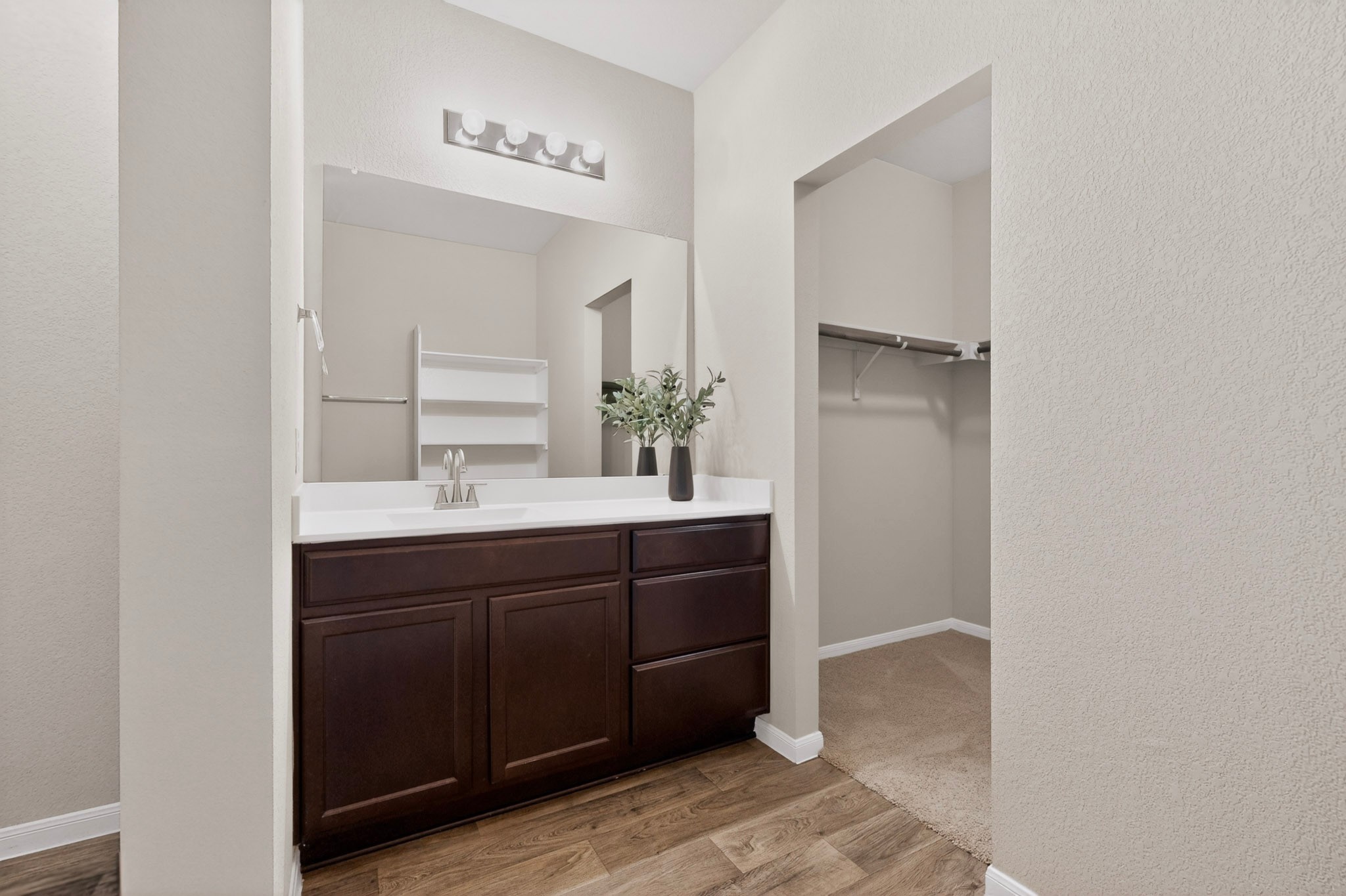 5905 Diamondleaf Bend Austin, TX 78724 - Photo 18 of 38 Vanity area featuring a dark wood-finish cabinet, white countertop, and single basin sink with a chrome faucet