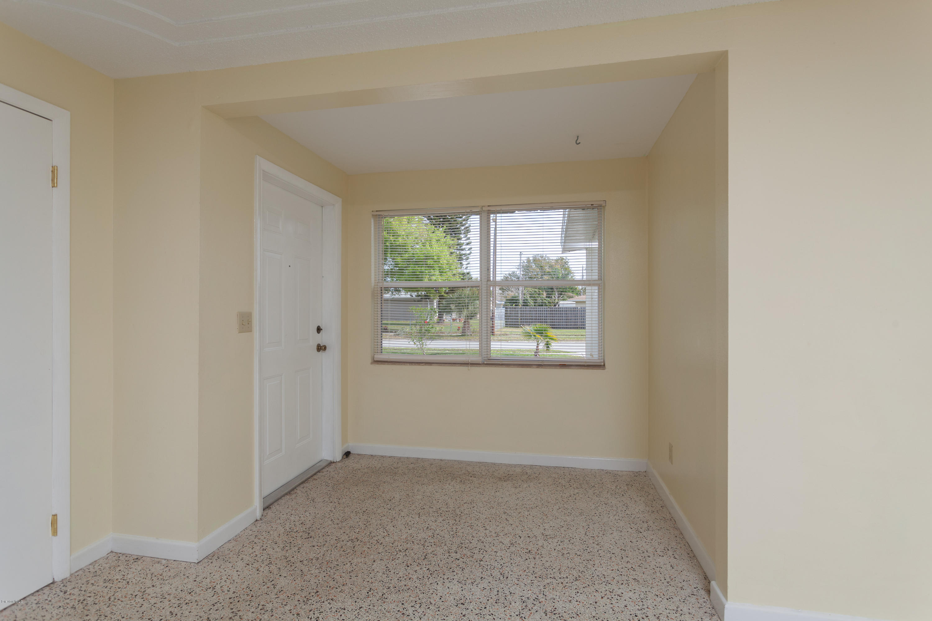 820 Sandgate Street Merritt Island, FL 32953 - Photo 3 of 13 an empty room with a window