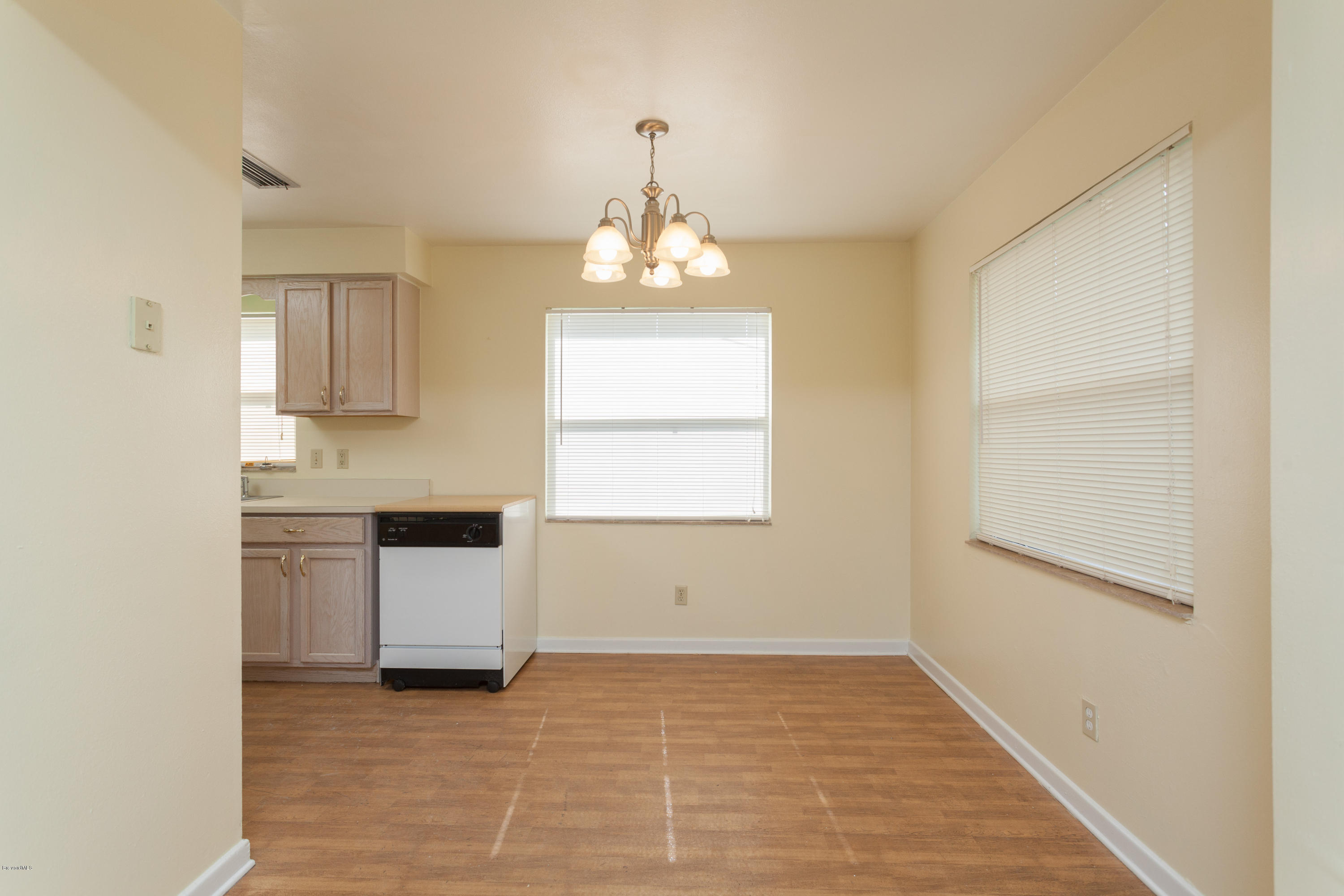 820 Sandgate Street Merritt Island, FL 32953 - Photo 5 of 13 a kitchen with granite countertop white cabinets and white appliances