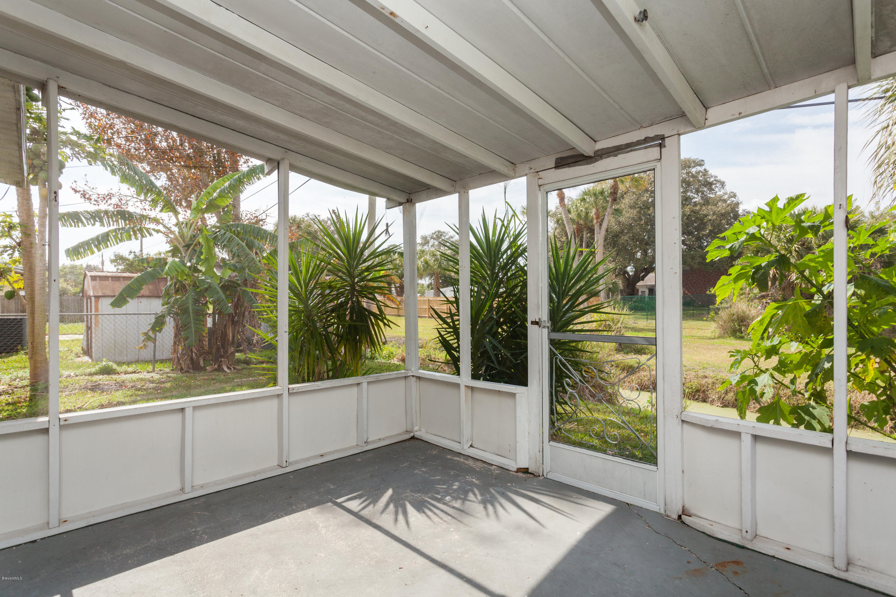 820 Sandgate Street Merritt Island, FL 32953 - Photo 6 of 13 a view of a glass door and a yard