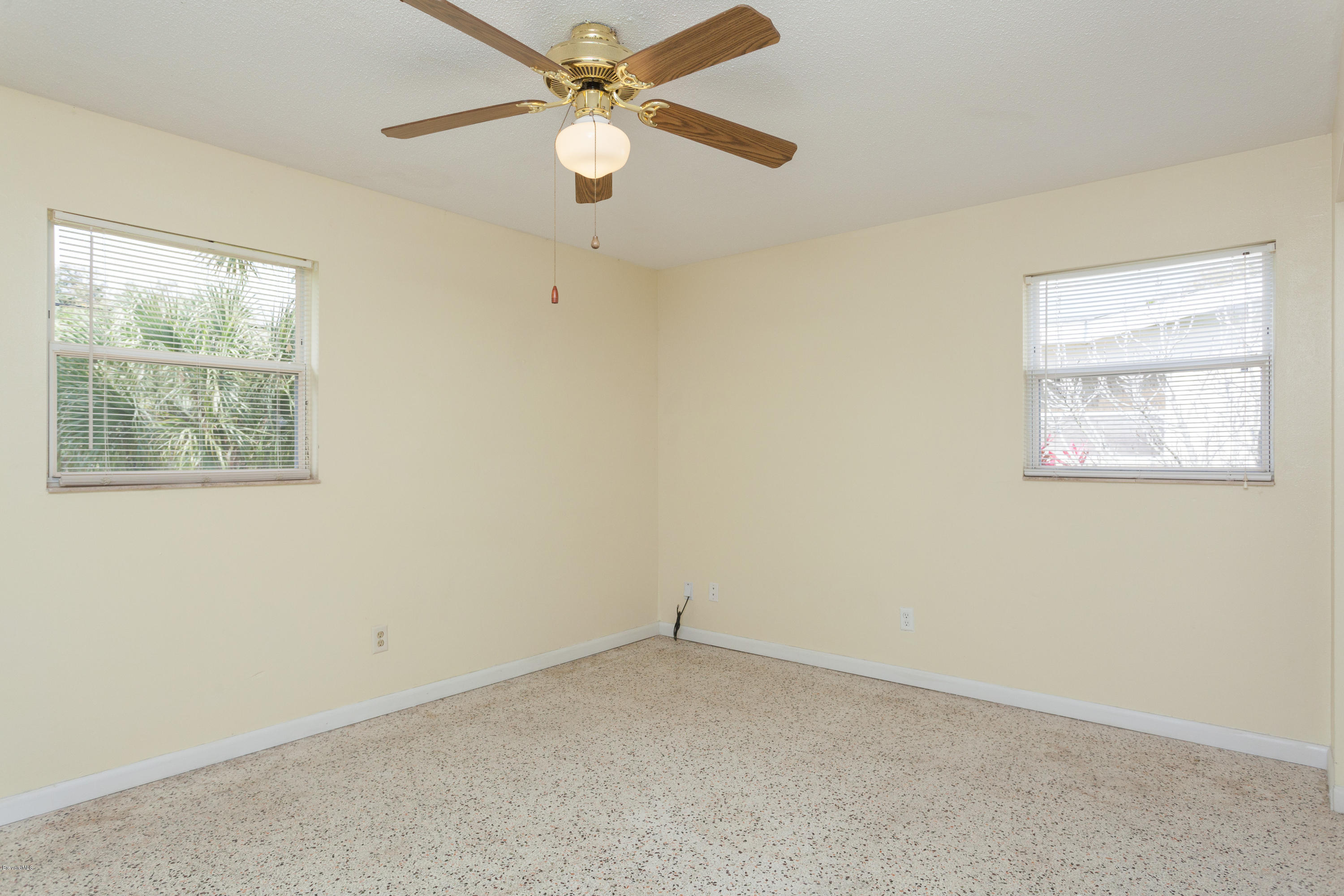 820 Sandgate Street Merritt Island, FL 32953 - Photo 7 of 13 an empty room with a window and a fan