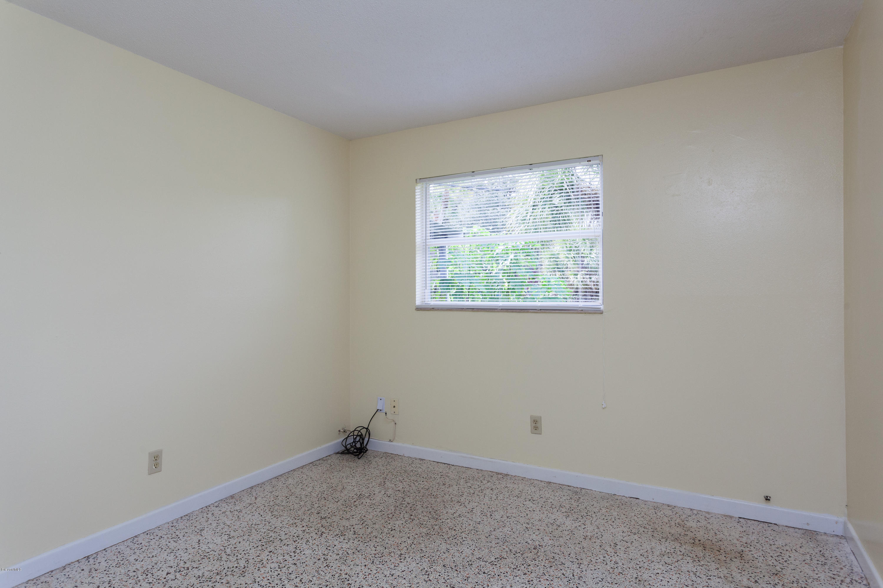 820 Sandgate Street Merritt Island, FL 32953 - Photo 9 of 13 an empty room with windows