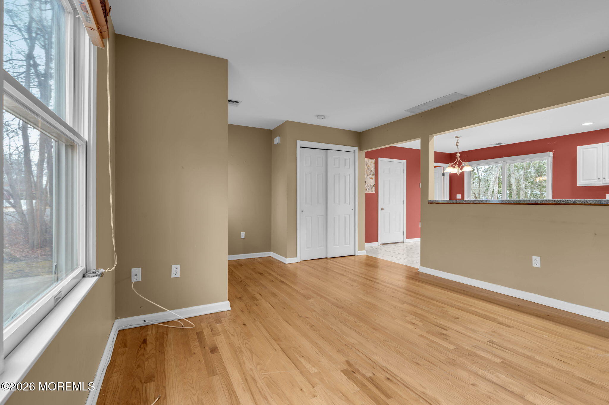 9 Forecastle Way Waretown, NJ 08758 - Photo 9 of 51 a view of an empty room with window and wooden floor
