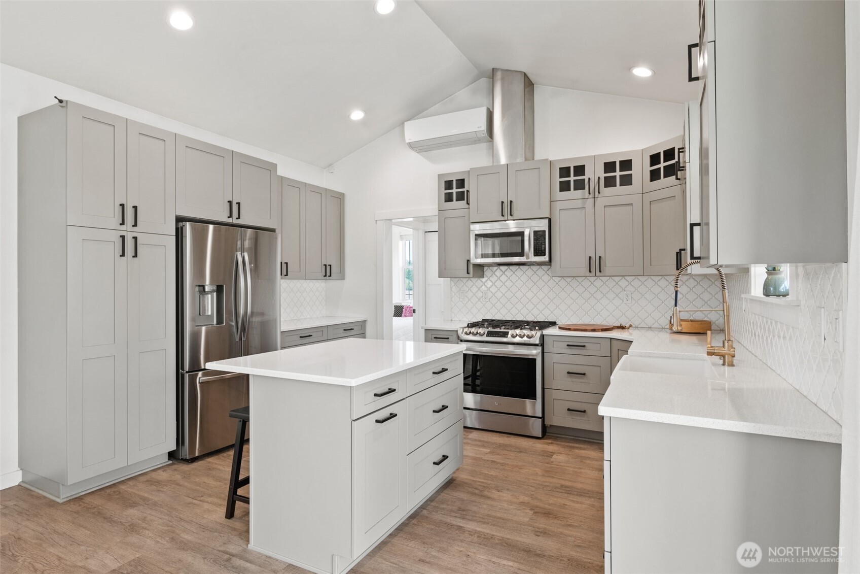 195 Laura Lane Sequim, WA 98382 - Photo 16 of 32 a kitchen with white cabinets and stainless steel appliances