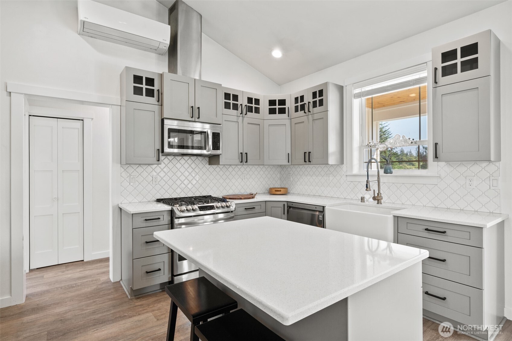195 Laura Lane Sequim, WA 98382 - Photo 18 of 32 a kitchen with stainless steel appliances a stove a sink cabinets and a refrigerator