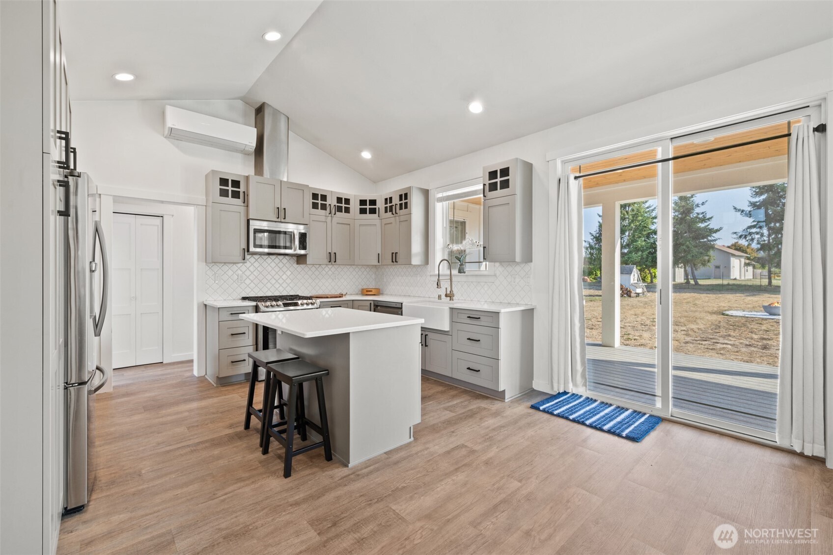 195 Laura Lane Sequim, WA 98382 - Photo 21 of 32 a kitchen with refrigerator cabinets and wooden floor