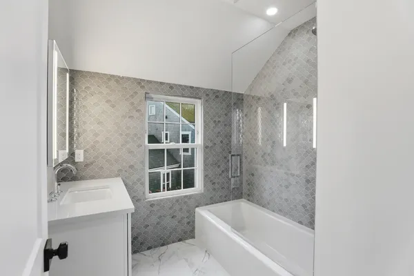 an aerial view of residential building with outdoor space and ocean