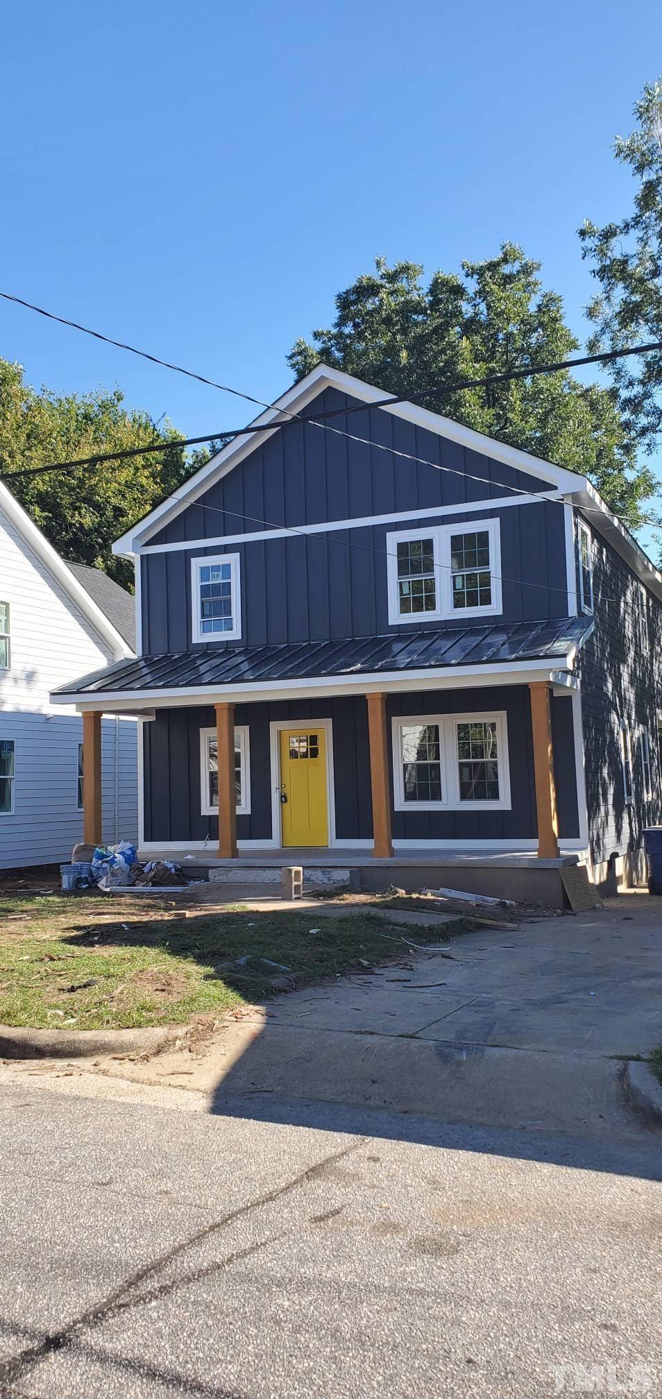 1412 East Jones Street Raleigh, NC 27610 - Photo 1 of 41 a view of a big house with a big yard