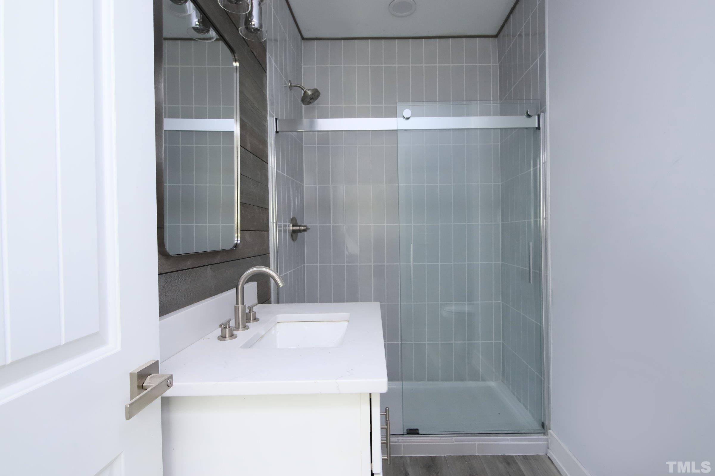 1412 East Jones Street Raleigh, NC 27610 - Photo 14 of 41 a bathroom with a sink shower and a mirror
