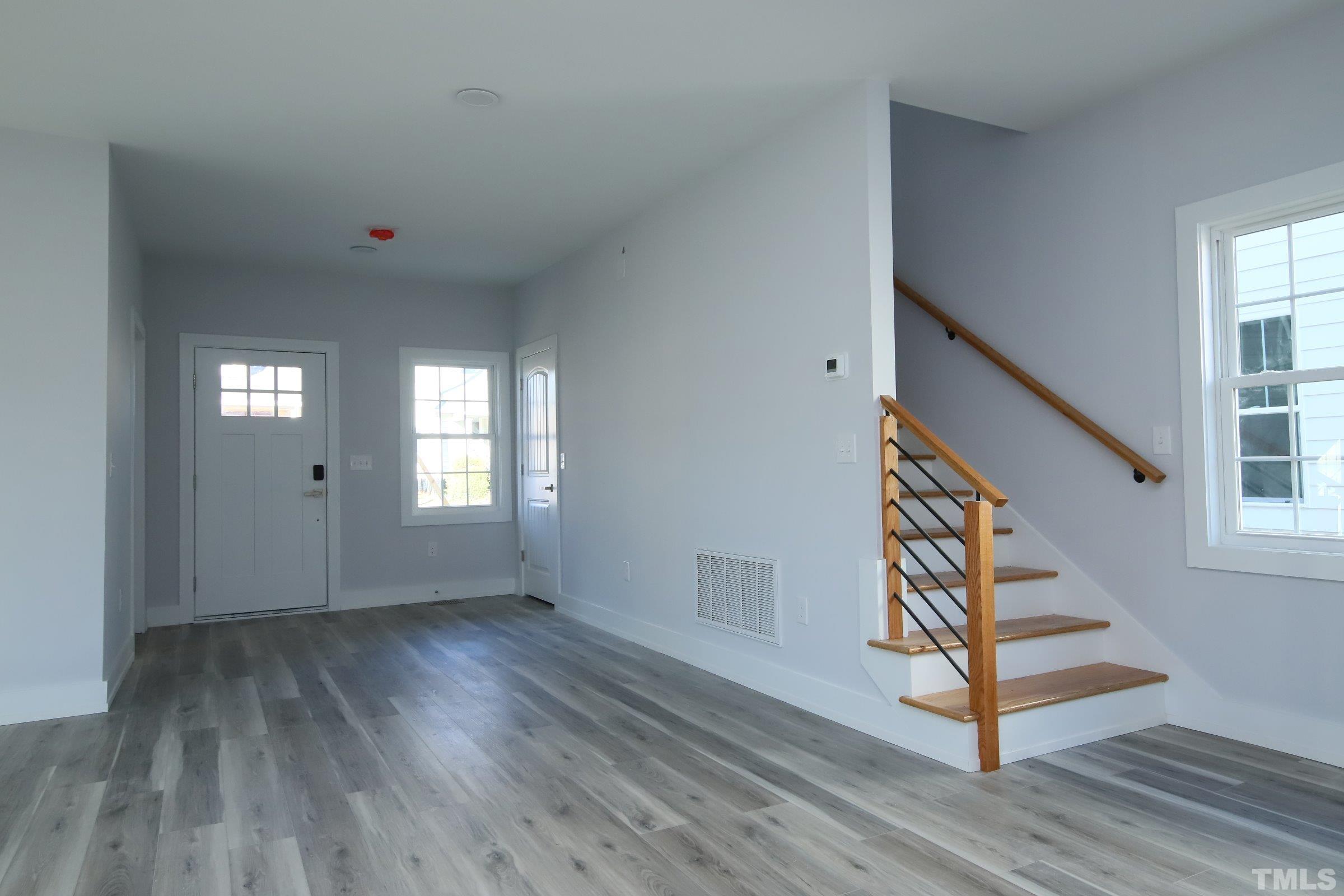 1412 East Jones Street Raleigh, NC 27610 - Photo 15 of 41 wooden floor in an empty room with a window