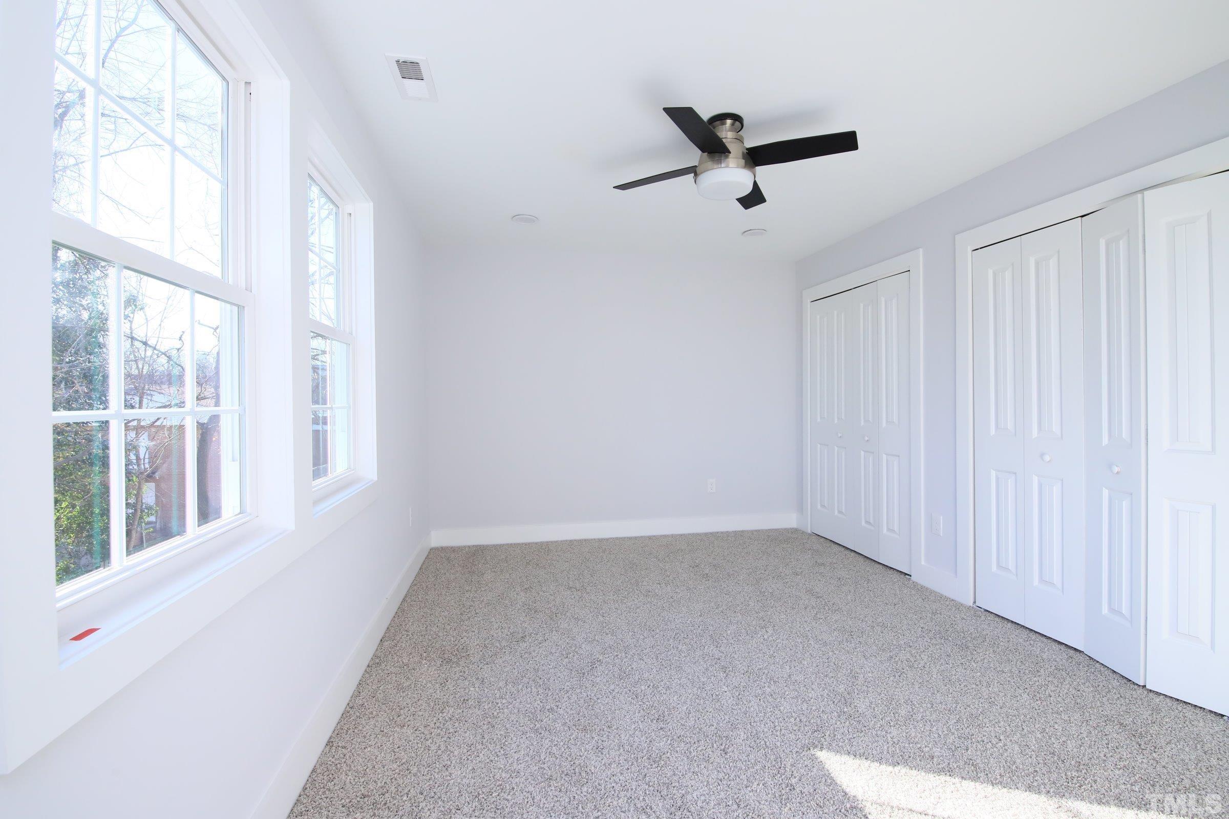 1412 East Jones Street Raleigh, NC 27610 - Photo 20 of 41 a view of a livingroom with a ceiling fan and window