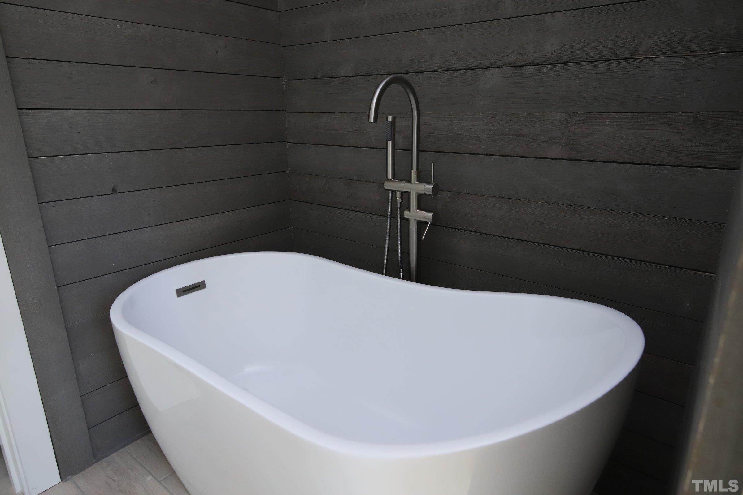 1412 East Jones Street Raleigh, NC 27610 - Photo 24 of 41 a white tub sitting in a bathroom