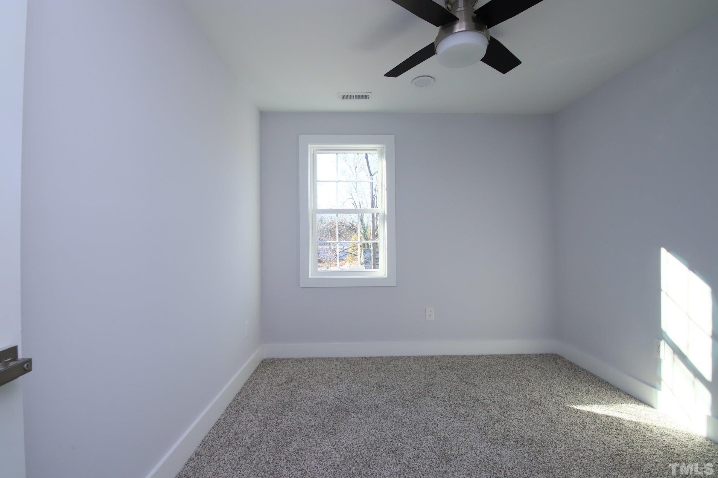 1412 East Jones Street Raleigh, NC 27610 - Photo 27 of 41 an empty room with a window and a fan