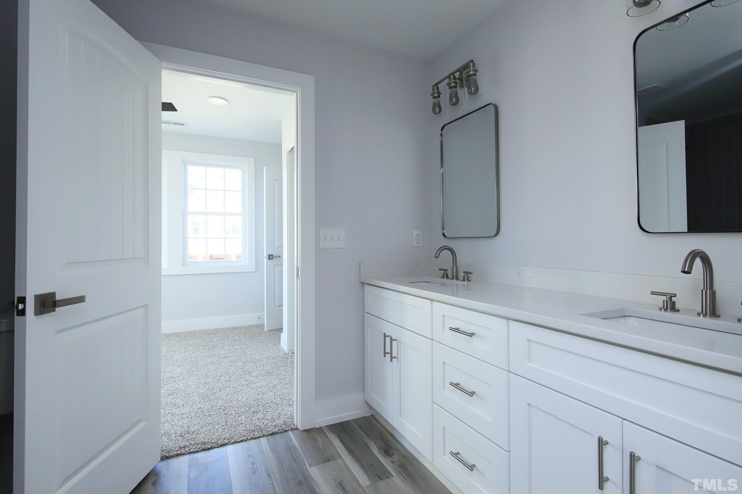 1412 East Jones Street Raleigh, NC 27610 - Photo 29 of 41 a bathroom with 2 sink and a mirror