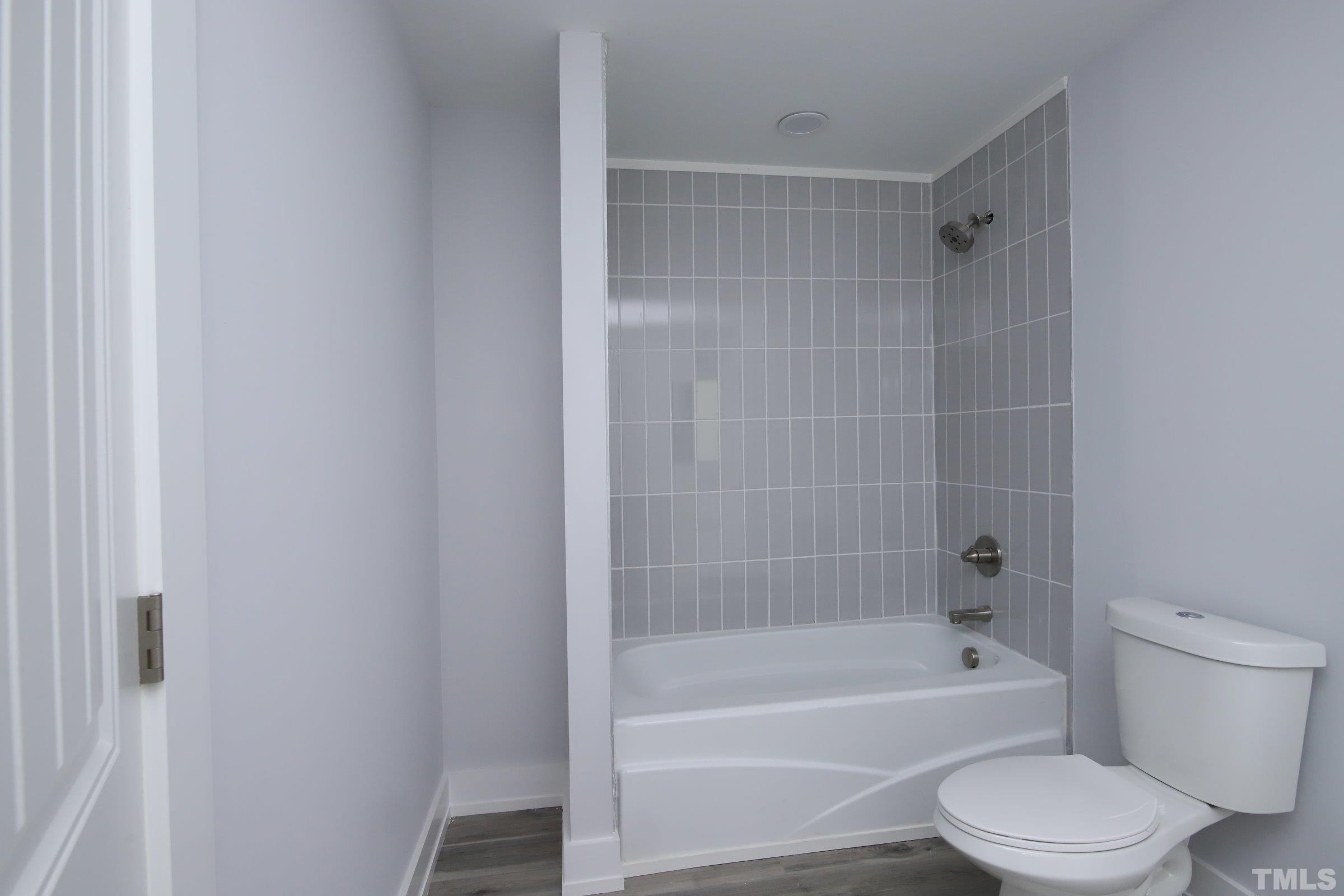 1412 East Jones Street Raleigh, NC 27610 - Photo 30 of 41 a bathroom with a toilet and a bathtub