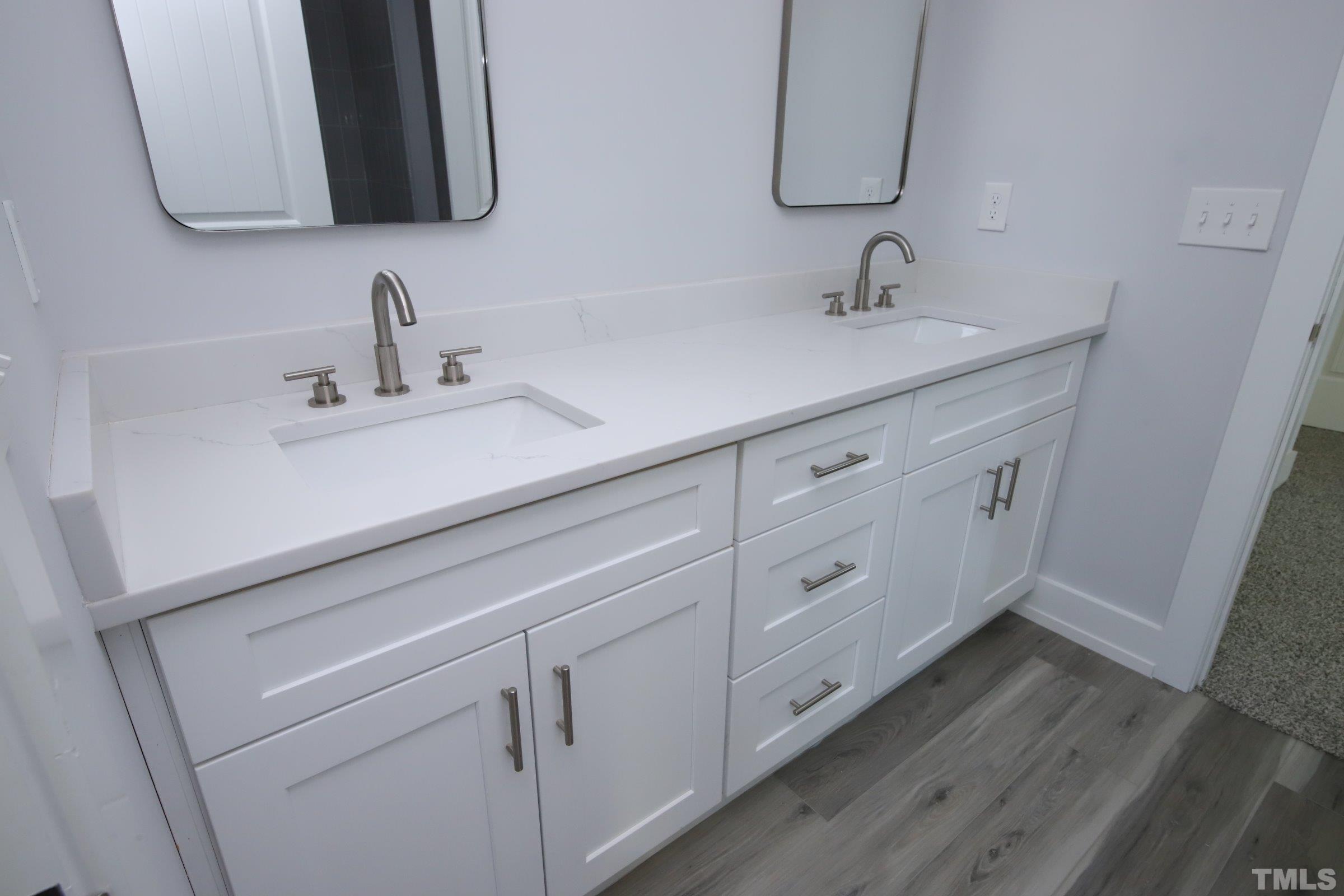 1412 East Jones Street Raleigh, NC 27610 - Photo 31 of 41 a bathroom with a sink and a mirror