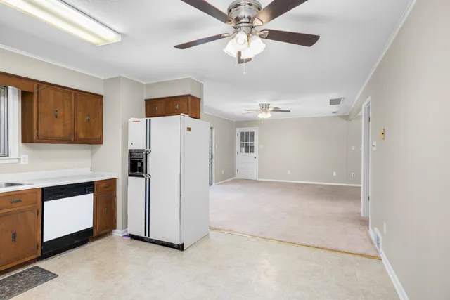 a view of a kitchen with refrigerator and an empty refrigerator