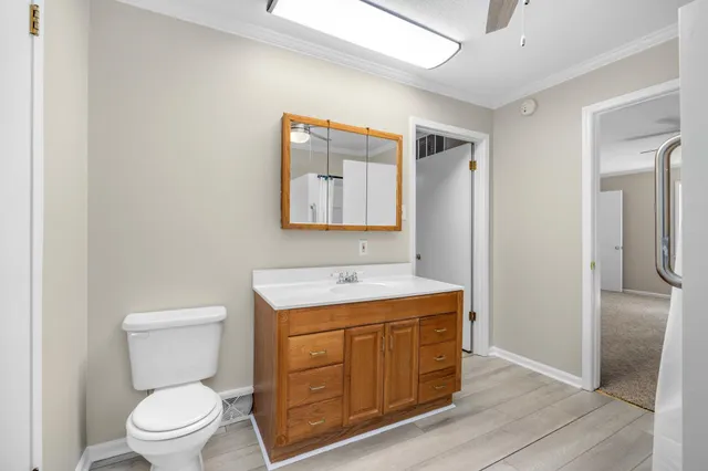 a bathroom with a toilet a sink and mirror