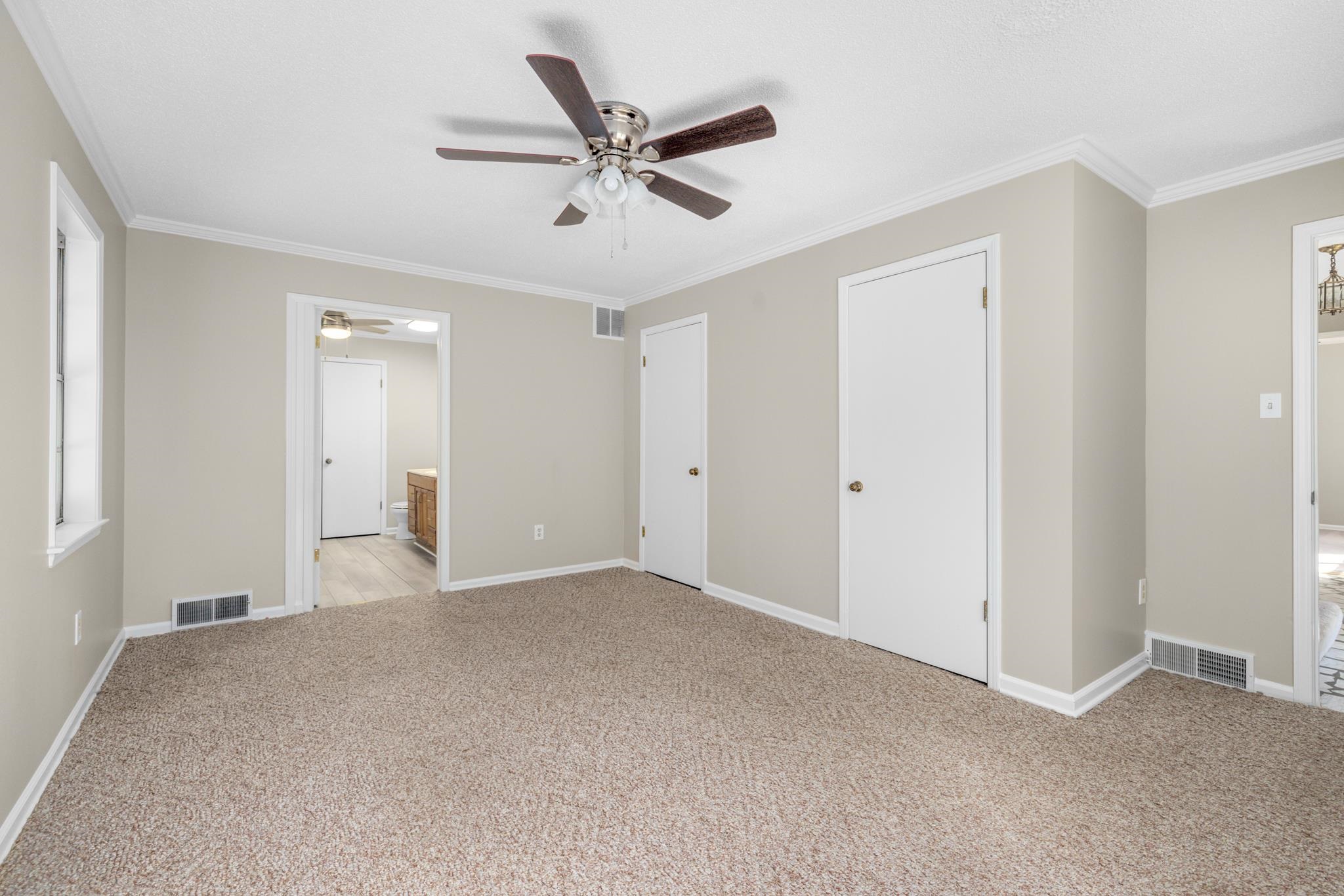 766 Fite Road Memphis, TN 38127 - Photo 17 of 30 a view of a livingroom with a ceiling fan & windows