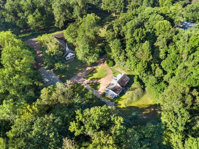 an aerial view of residential house with outdoor space and swimming pool