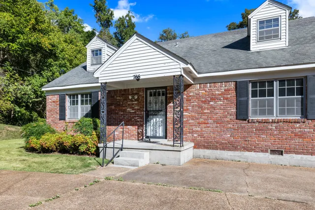 a front view of a house with garden