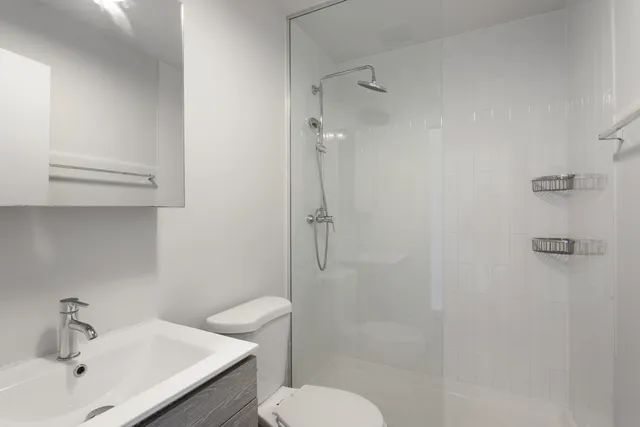a bathroom with a sink toilet and shower