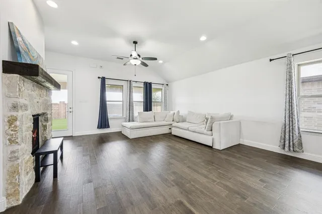 a large white kitchen with lots of counter space wooden floor and appliances