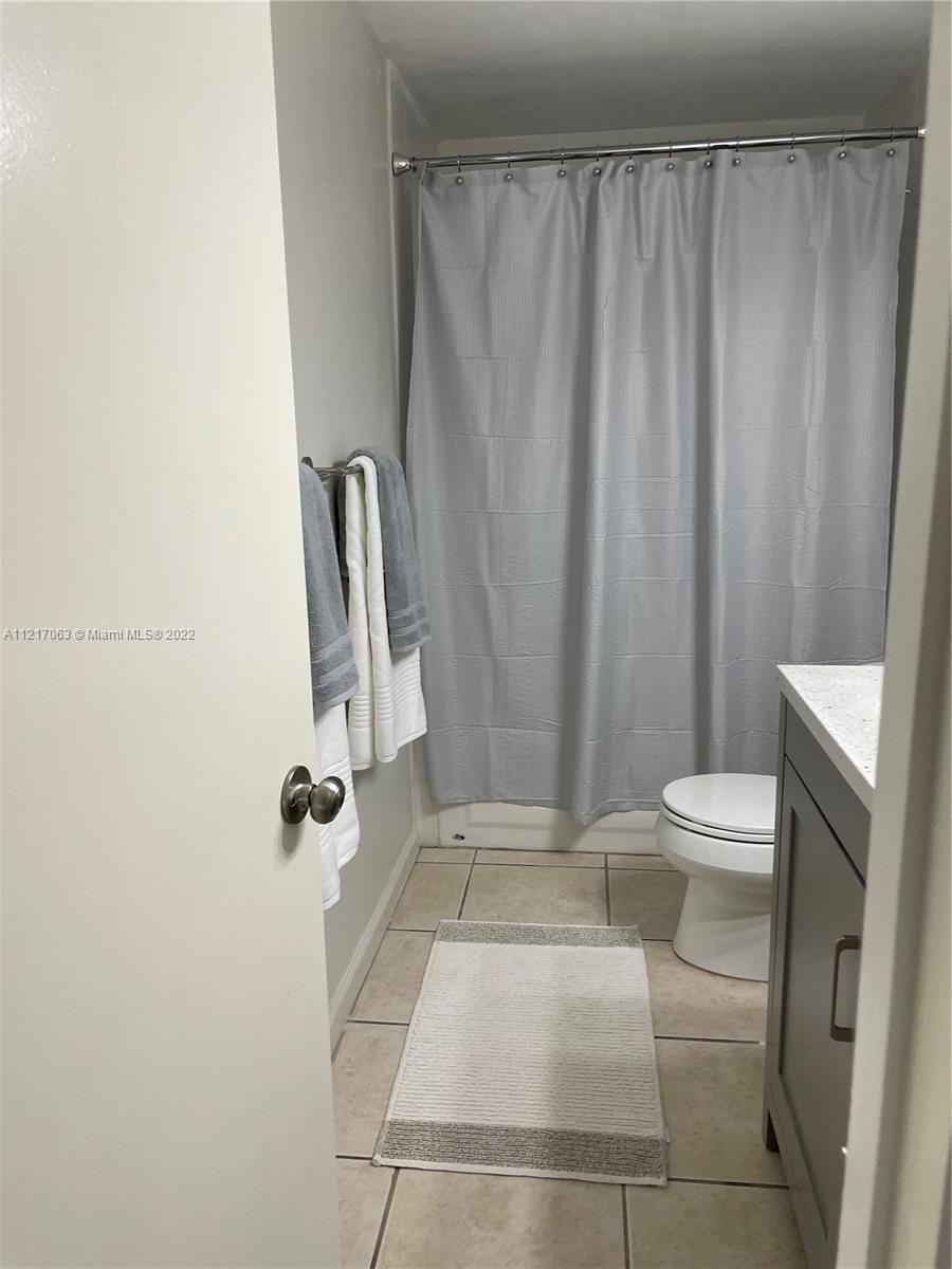 9611 Southwest 77th Avenue, Unit 108A Miami, FL 33156 - Photo 11 of 12 a bathroom with a sink and toilet