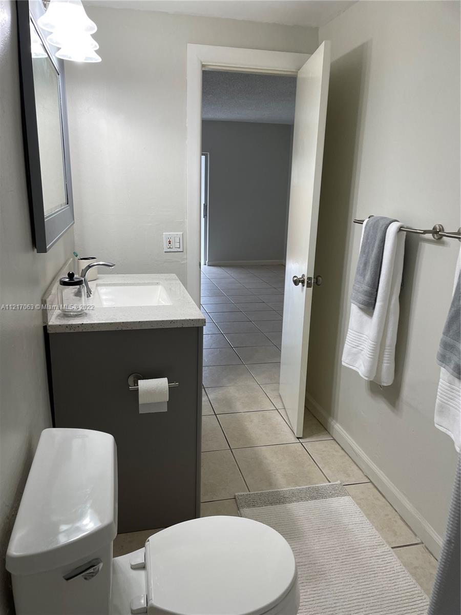 9611 Southwest 77th Avenue, Unit 108A Miami, FL 33156 - Photo 12 of 12 a bathroom with a sink toilet and shower