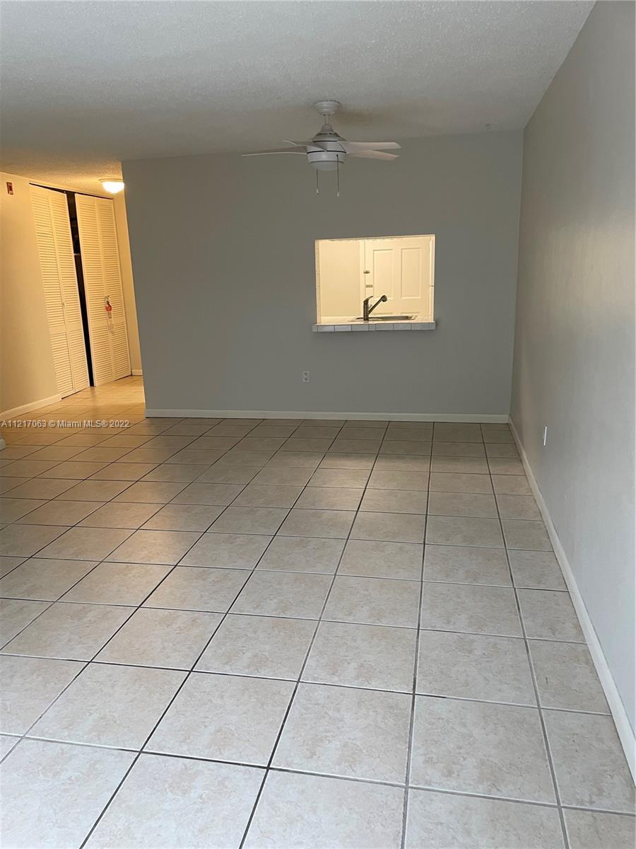 9611 Southwest 77th Avenue, Unit 108A Miami, FL 33156 - Photo 5 of 12 a view of an empty room with a window
