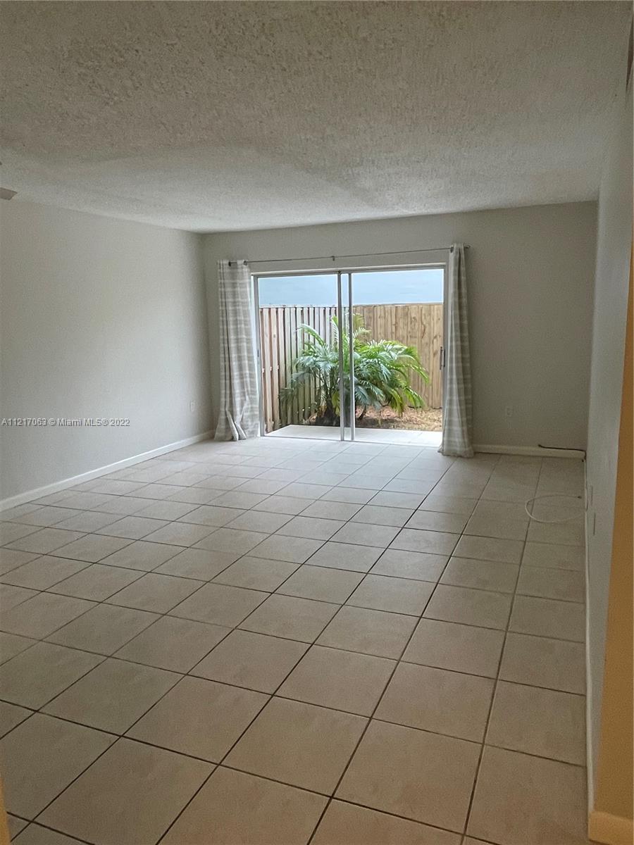 9611 Southwest 77th Avenue, Unit 108A Miami, FL 33156 - Photo 6 of 12 a view of an empty room with a window