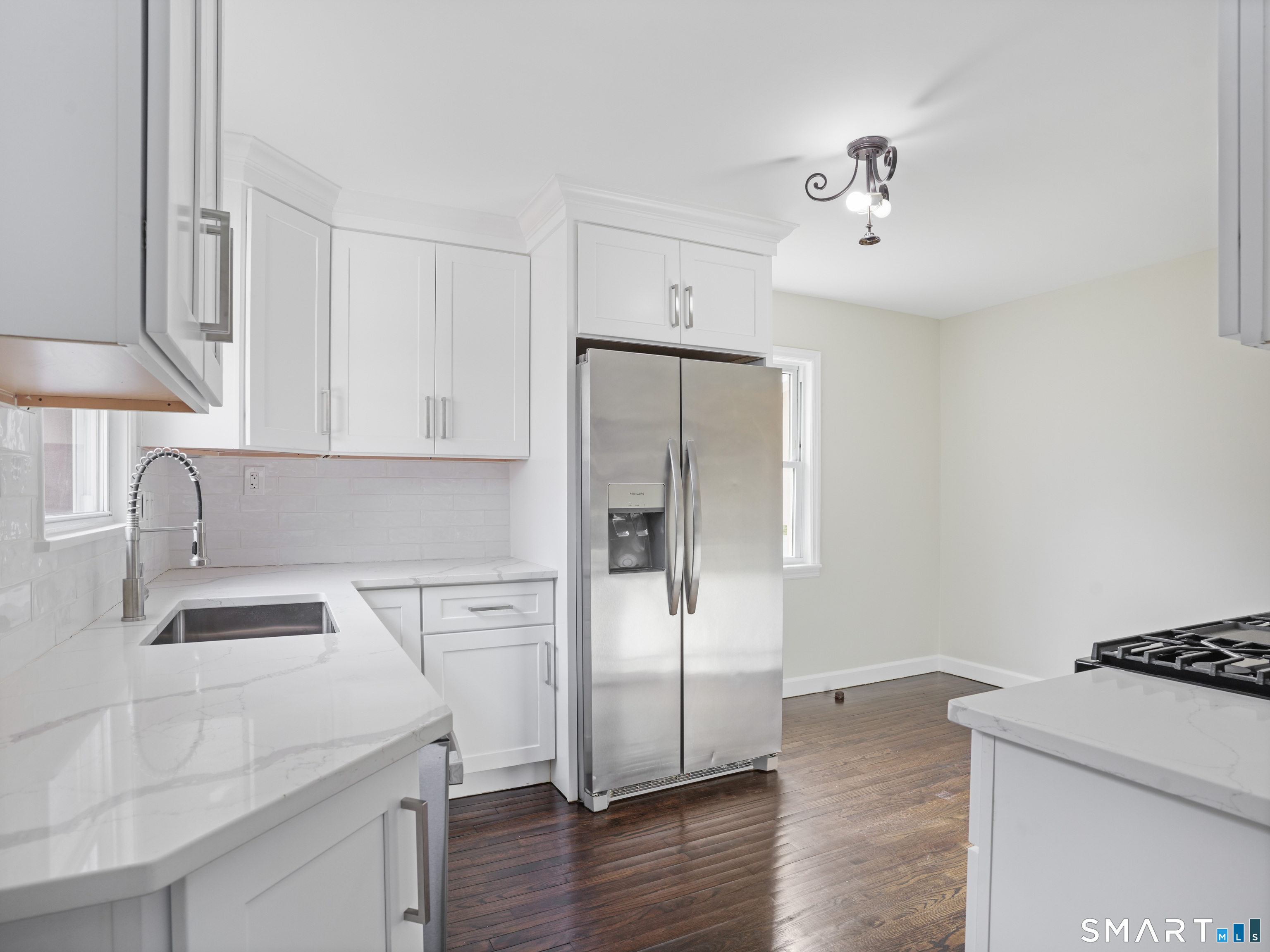 3125 Old Town Road Bridgeport, CT 06606 - Photo 21 of 24 a kitchen with stainless steel appliances granite countertop a sink stove and refrigerator