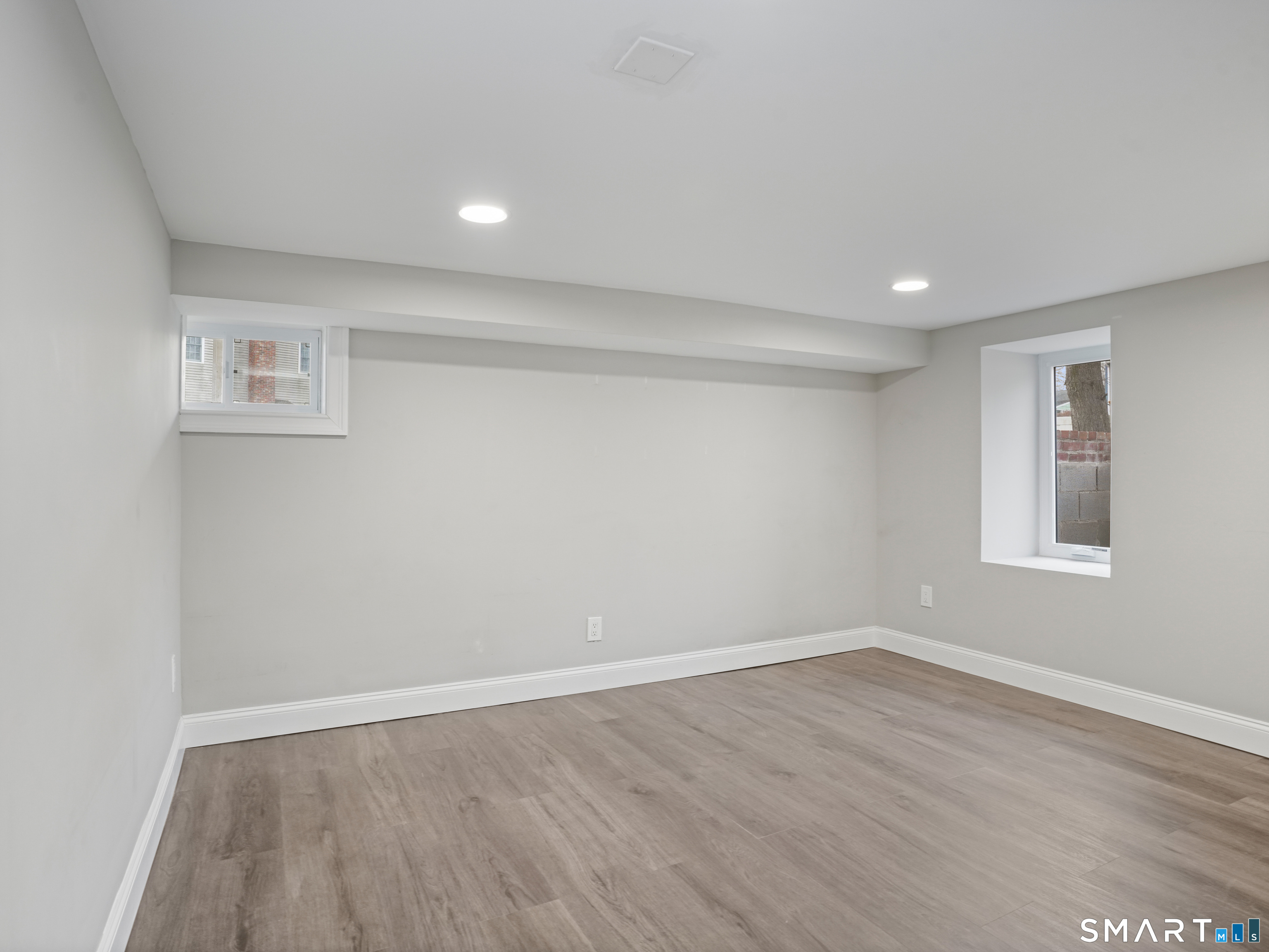 3125 Old Town Road Bridgeport, CT 06606 - Photo 3 of 24 a view of empty room with wooden floor and fan