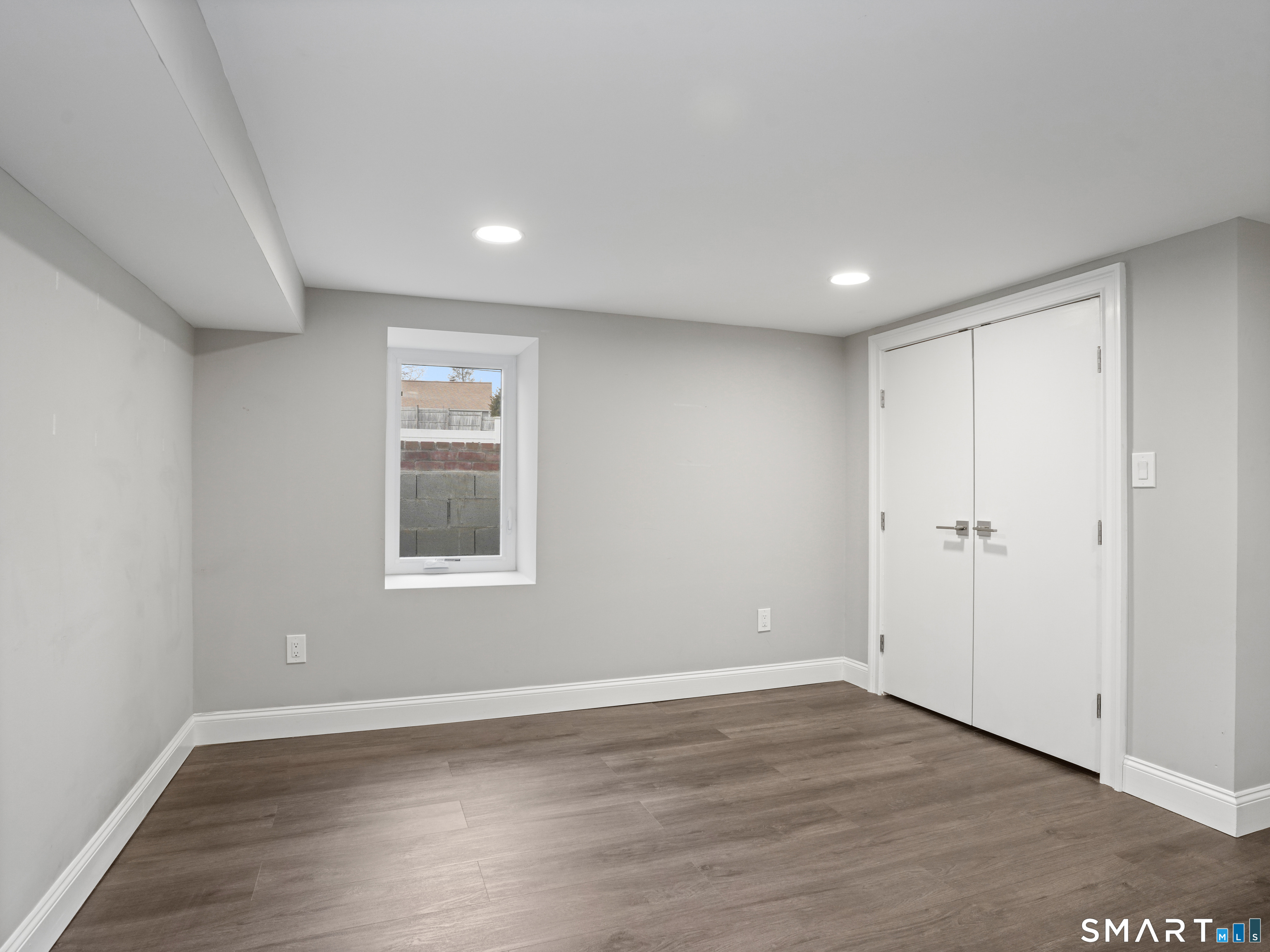 3125 Old Town Road Bridgeport, CT 06606 - Photo 4 of 24 a view of an empty room with wooden floor and a window