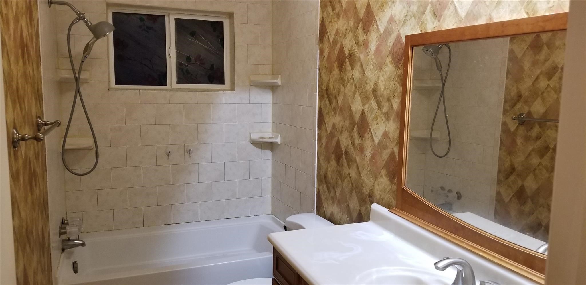 6702 Lynngate Drive Spring, TX 77373 - Photo 4 of 6 a bathroom with a bathtub and a shower