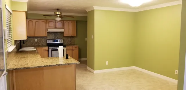 a kitchen with stainless steel appliances a sink a stove top oven a window