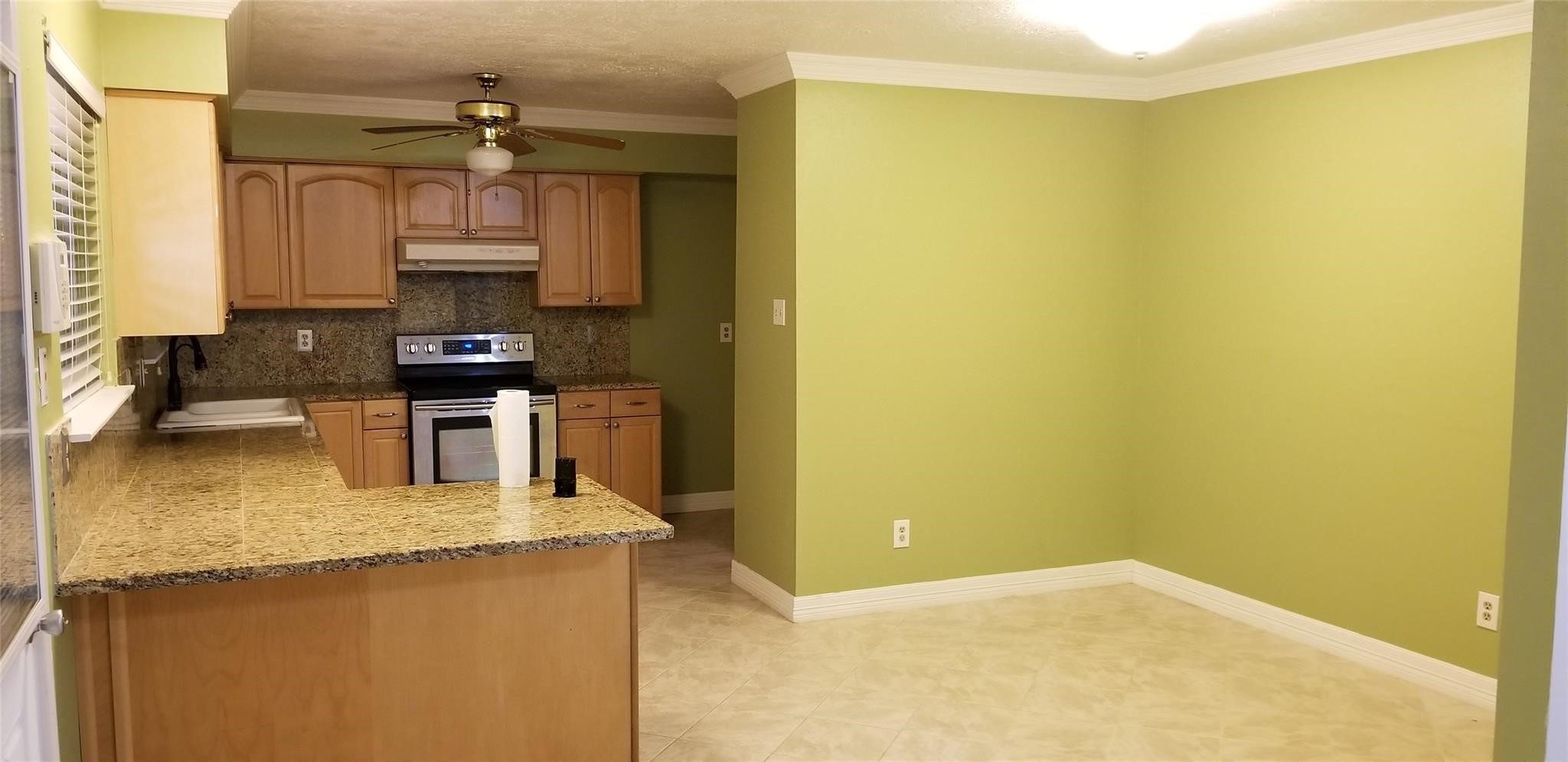 6702 Lynngate Drive Spring, TX 77373 - Photo 5 of 6 a kitchen with stainless steel appliances a sink a stove top oven a window