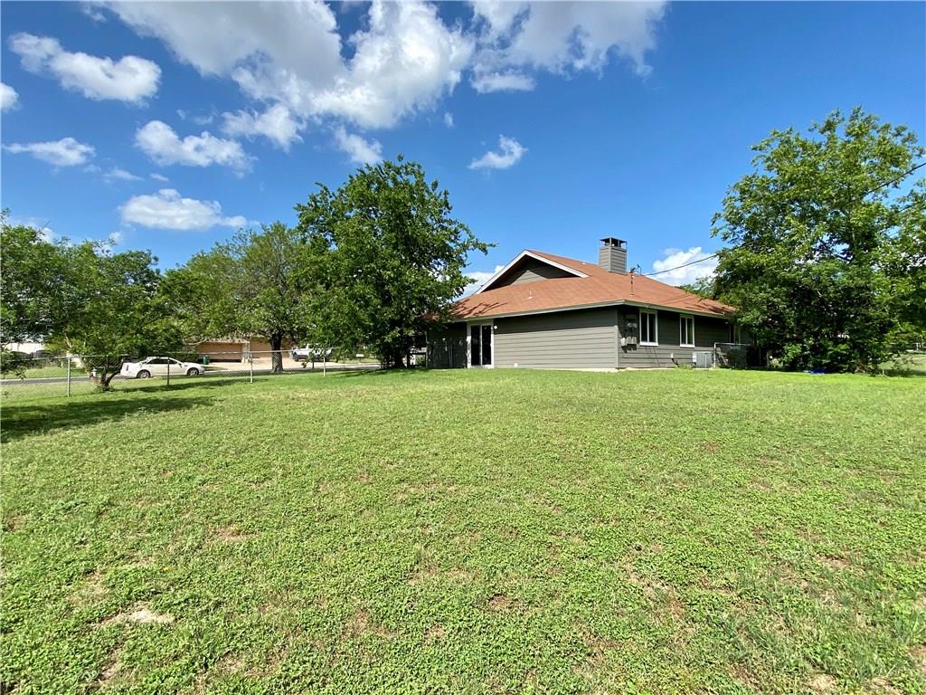 1715 Shadowview Drive, Unit B Austin, TX 78758 - Photo 7 of 28 A well-maintained structure with mature trees and a generously sized yard, perfect for outdoor living.