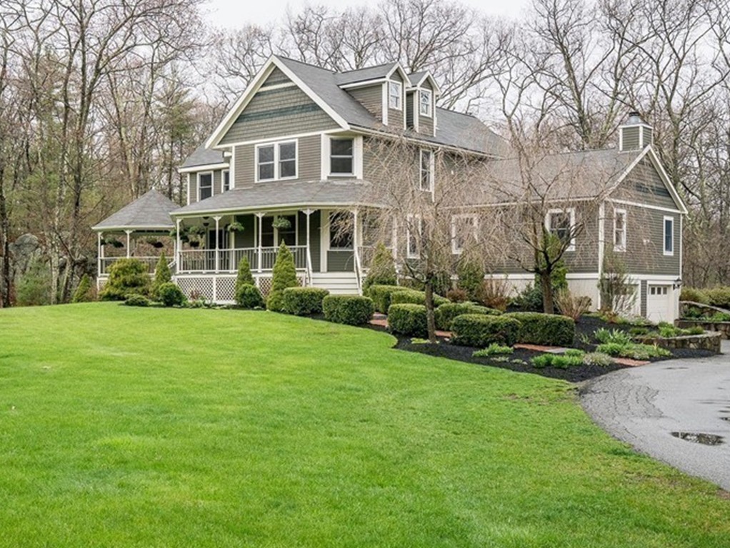 209 Main Street Boxford, MA 01921 - Photo 1 of 30 a front view of a house with a garden and plants