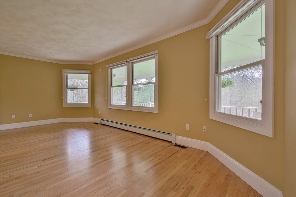 209 Main Street Boxford, MA 01921 - Photo 11 of 30 a view of an empty room with a window and wooden floor