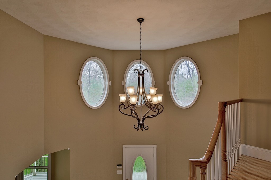 209 Main Street Boxford, MA 01921 - Photo 14 of 30 a group of light wood cabinets a clock on wall and a wooden floor